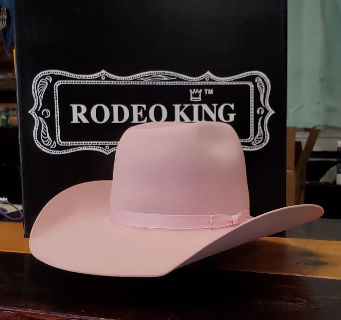 A pink Rodeo King felt cowboy hat on the counter at Take the Reins