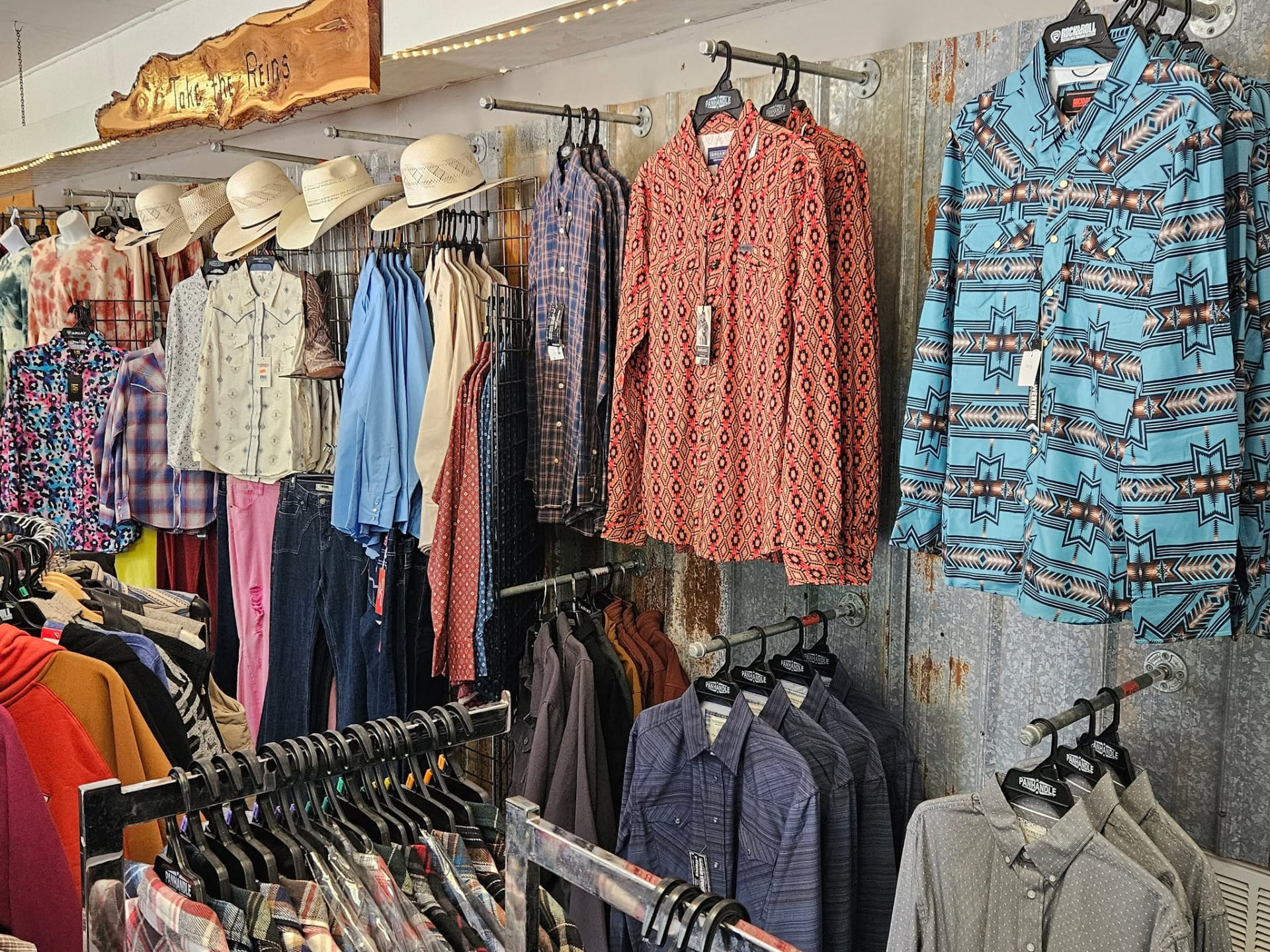 Inside Take the Reins: boots, hats and racks of western shirts around the counter