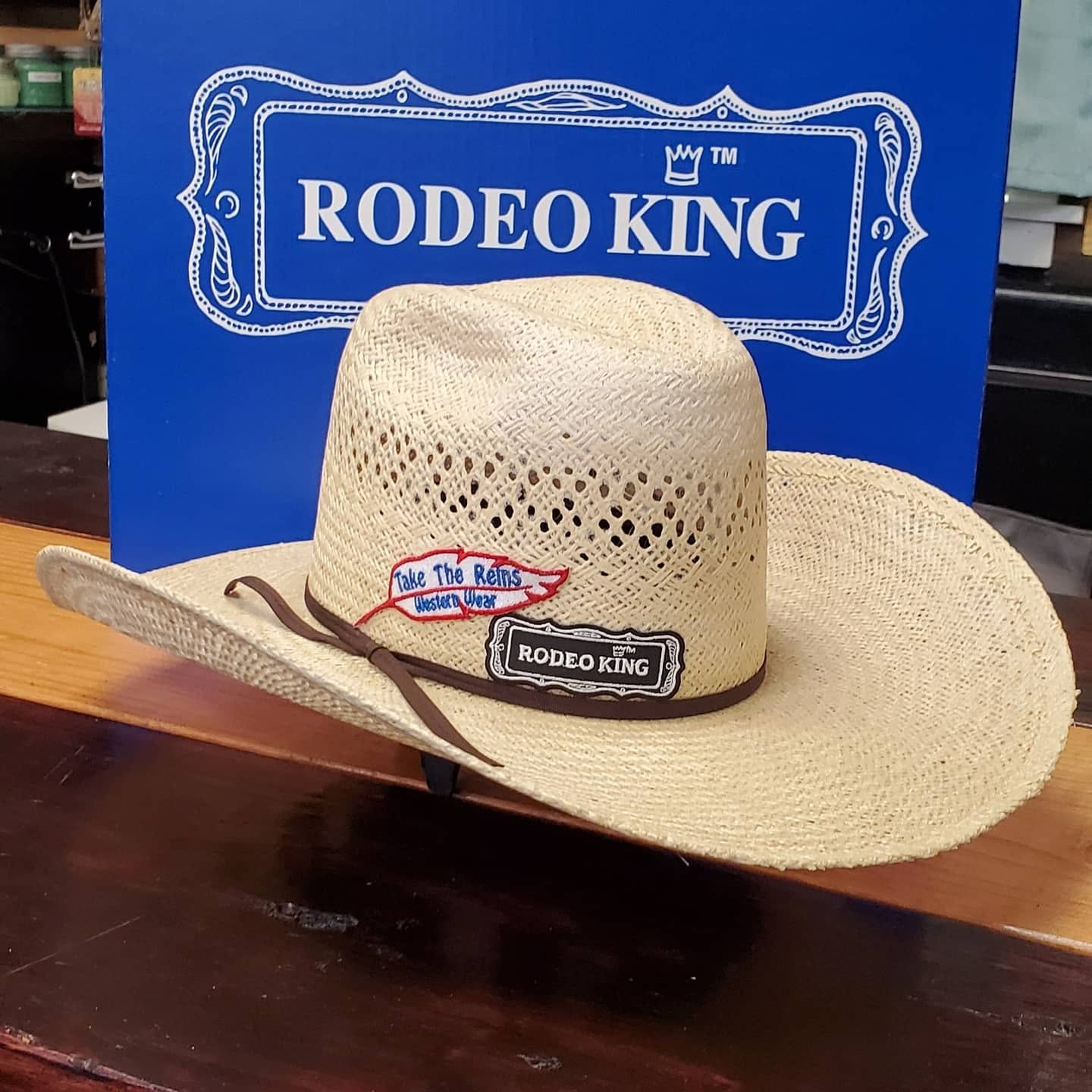 A Rodeo King straw cowboy hat with the Take the Reins patch, shaped in store